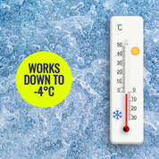 Thermometer on a frosty surface with text indicating temperature range