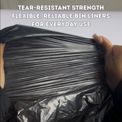 Black bin liner held by a hand with text about tear-resistant strength and reliability | Liquipak