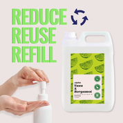 Hand using a small container with a large bottle labeled 'Reduce Reuse Refill' on a light background.