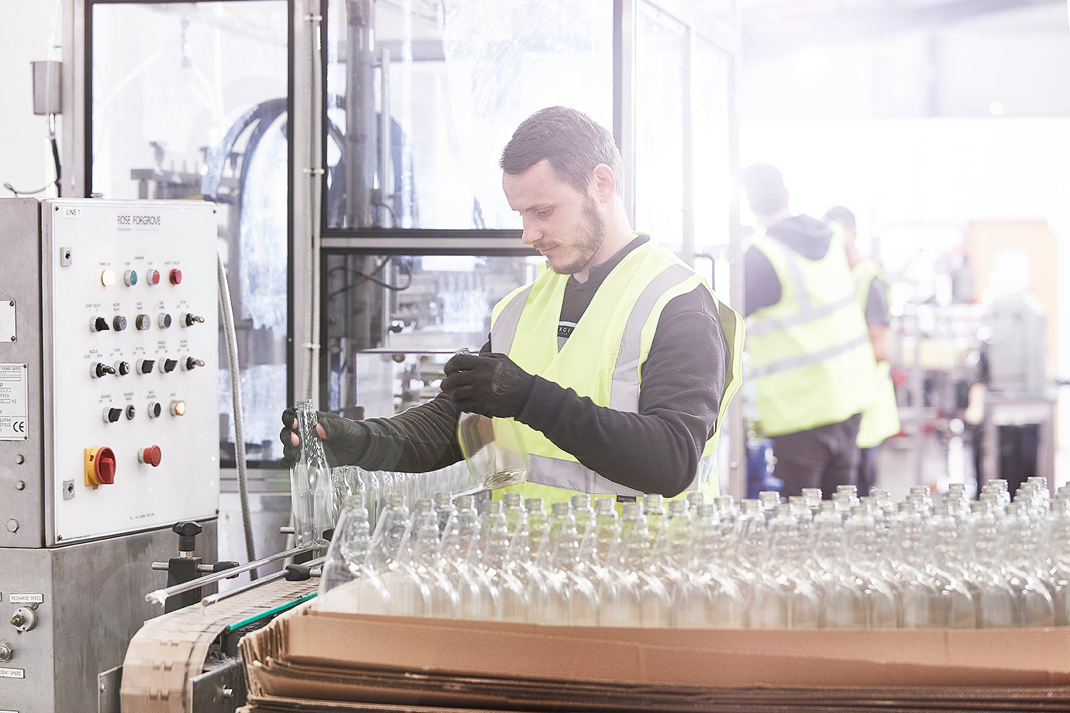 Liquipak-Darryl_putting_bottles_on_line_2bd70f95-8329-4d1a-9d07-70b343ced9d4.jpg